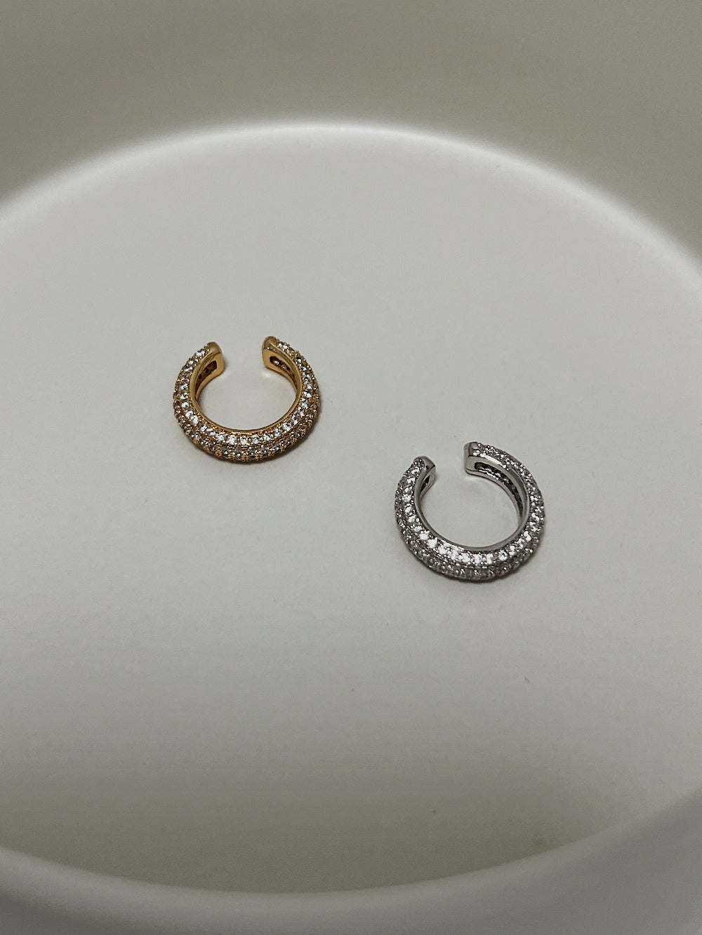 Stylish gold and silver ear cuff earrings with dazzling crystal accents