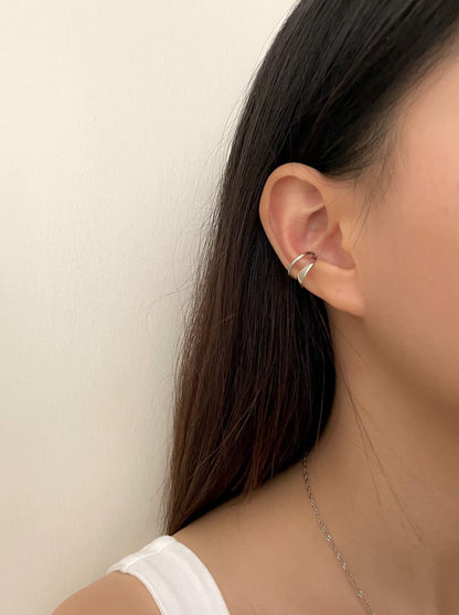 Quiet luxury ear stack on a model featuring the Beverly 18K gold PVD cuff.