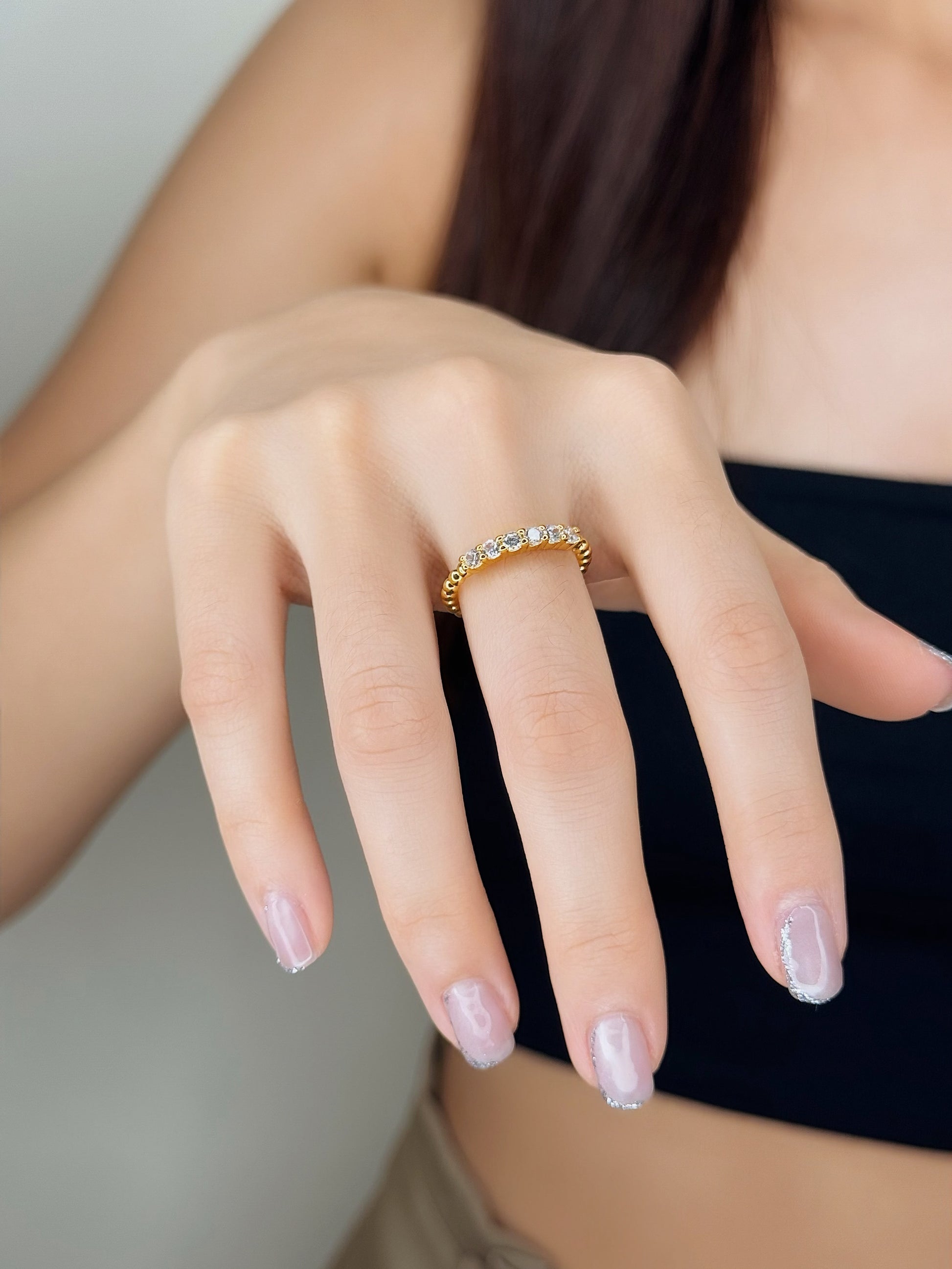 Influencer wearing and showing the gold nura beaded eternity ring