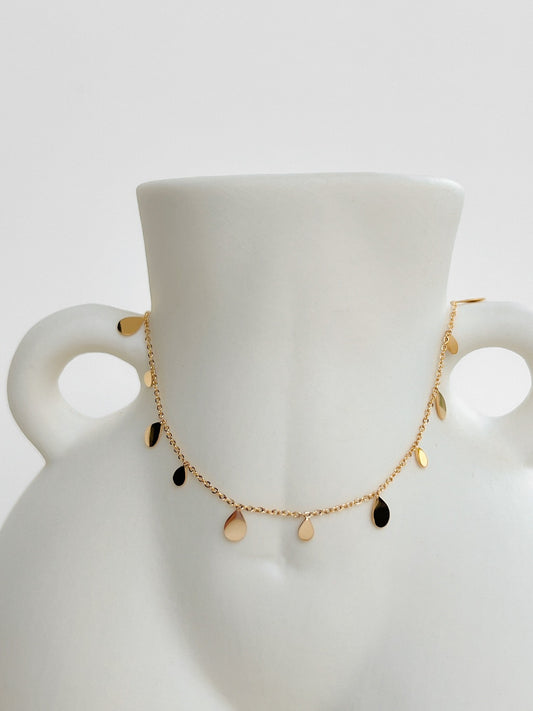 Romy bohemian teardrop pendant necklace showcasing a smooth gold droplet charm on white surface