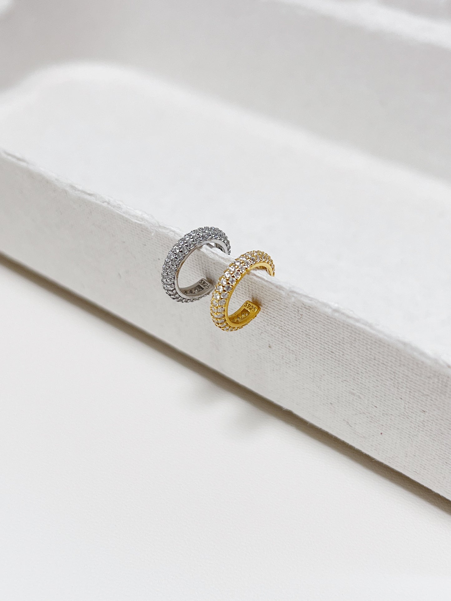 Close-up of gold Rose Pavé Ear Cuff showing three rows of sparkling crystals.