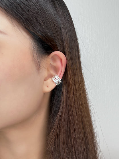 Profile view of model wearing the Carmela cuff to show the wide-band coverage on the cartilage.