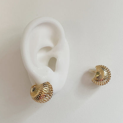 Close-up of the springless Japanese wire coil clip mechanism and clear non-slip silicone cushion inside a hollow dome earring.