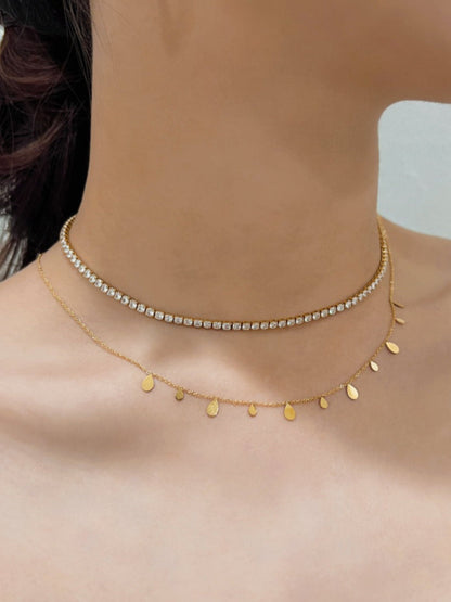 Model chest view stacking the romy bohemian teardrop pendant necklace and amelia gold tennis necklace