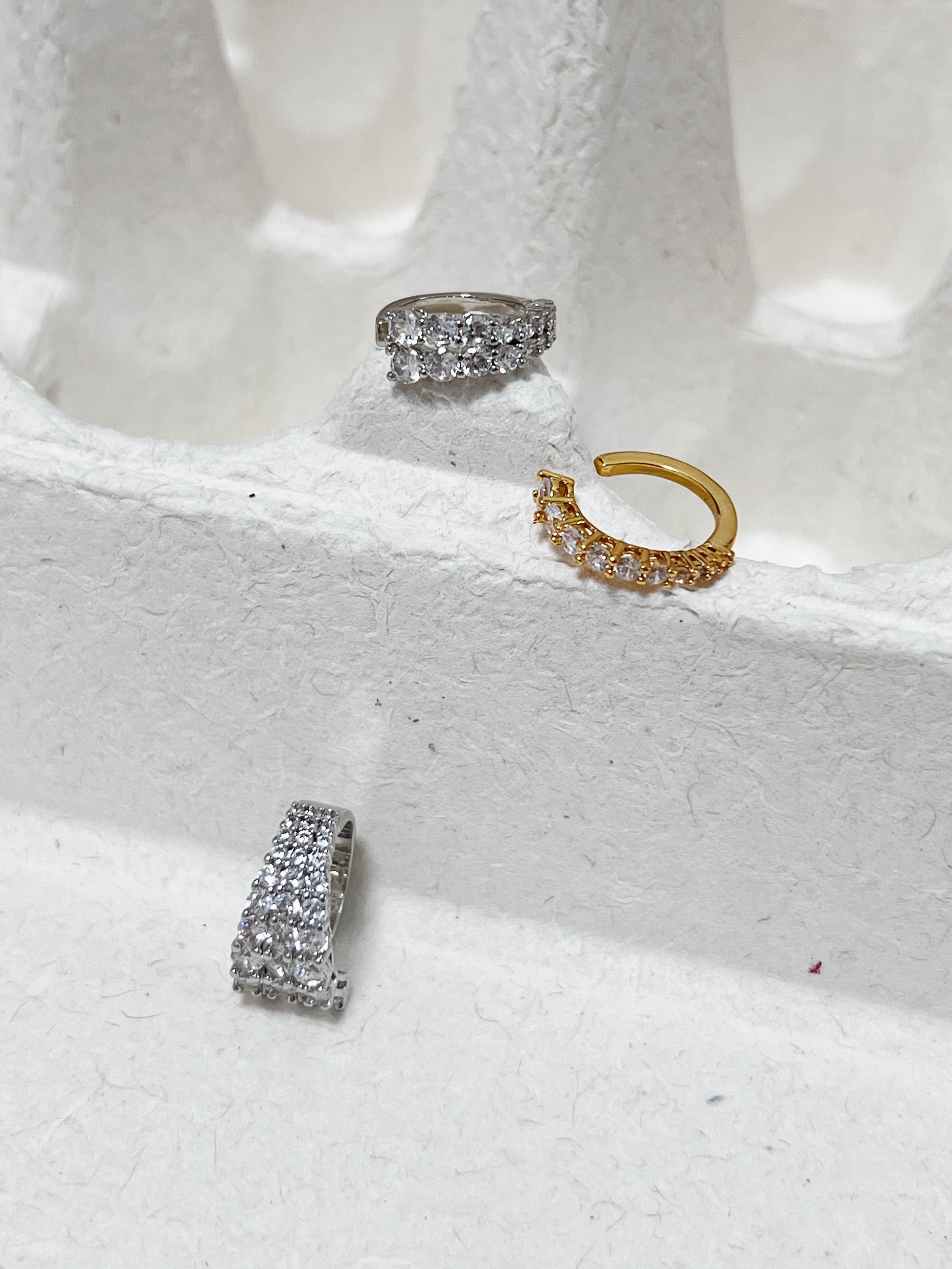 single row, double row and triple row pavé ear cuff in silver and gold displaying high-shine