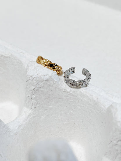 Industrial Silver Louie Quilted Ear Cuff on white architectural stone.