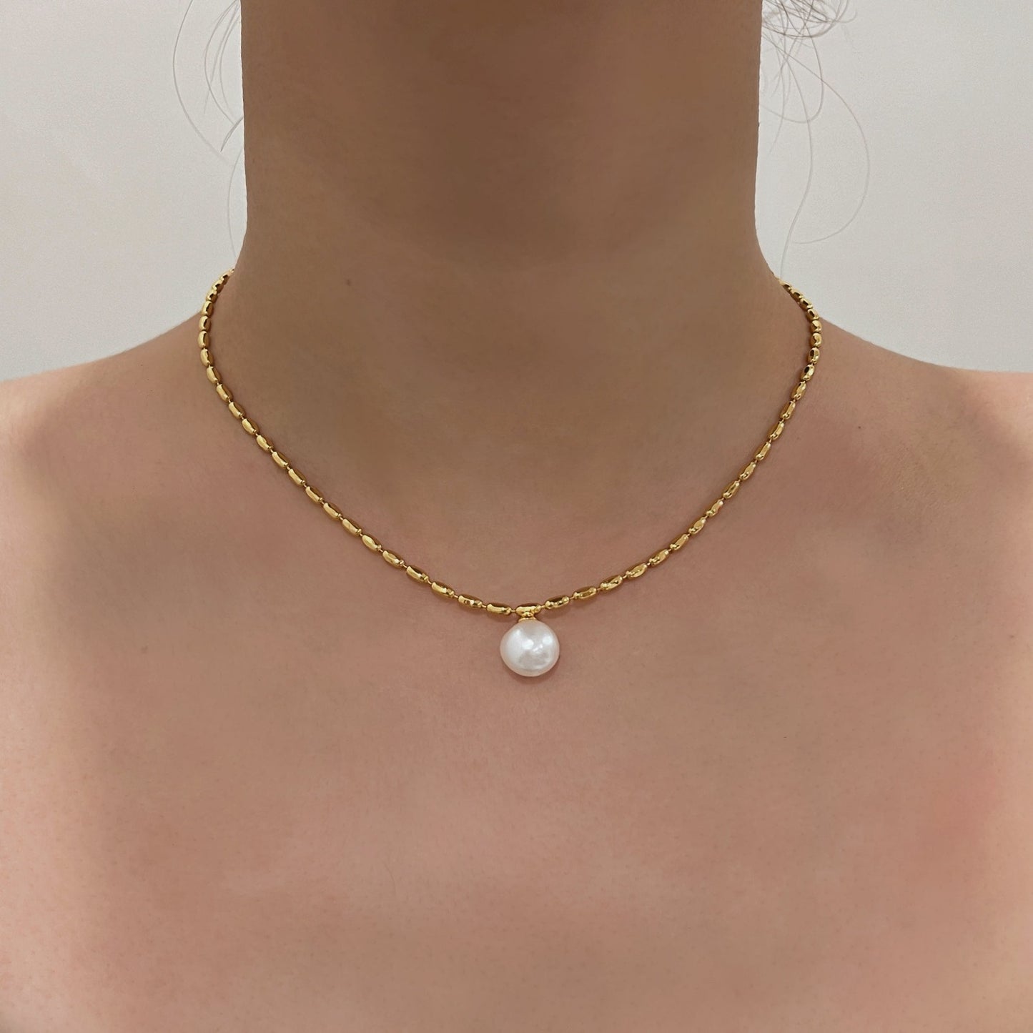 Close up of a professional woman wearing skin safe non tarnish premium gold demi fine jewelry