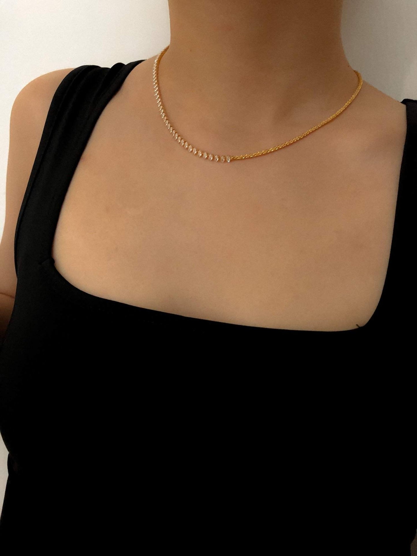 Editorial style jewelry lookbook photo highlighting clear gemstone sparkle over tank top