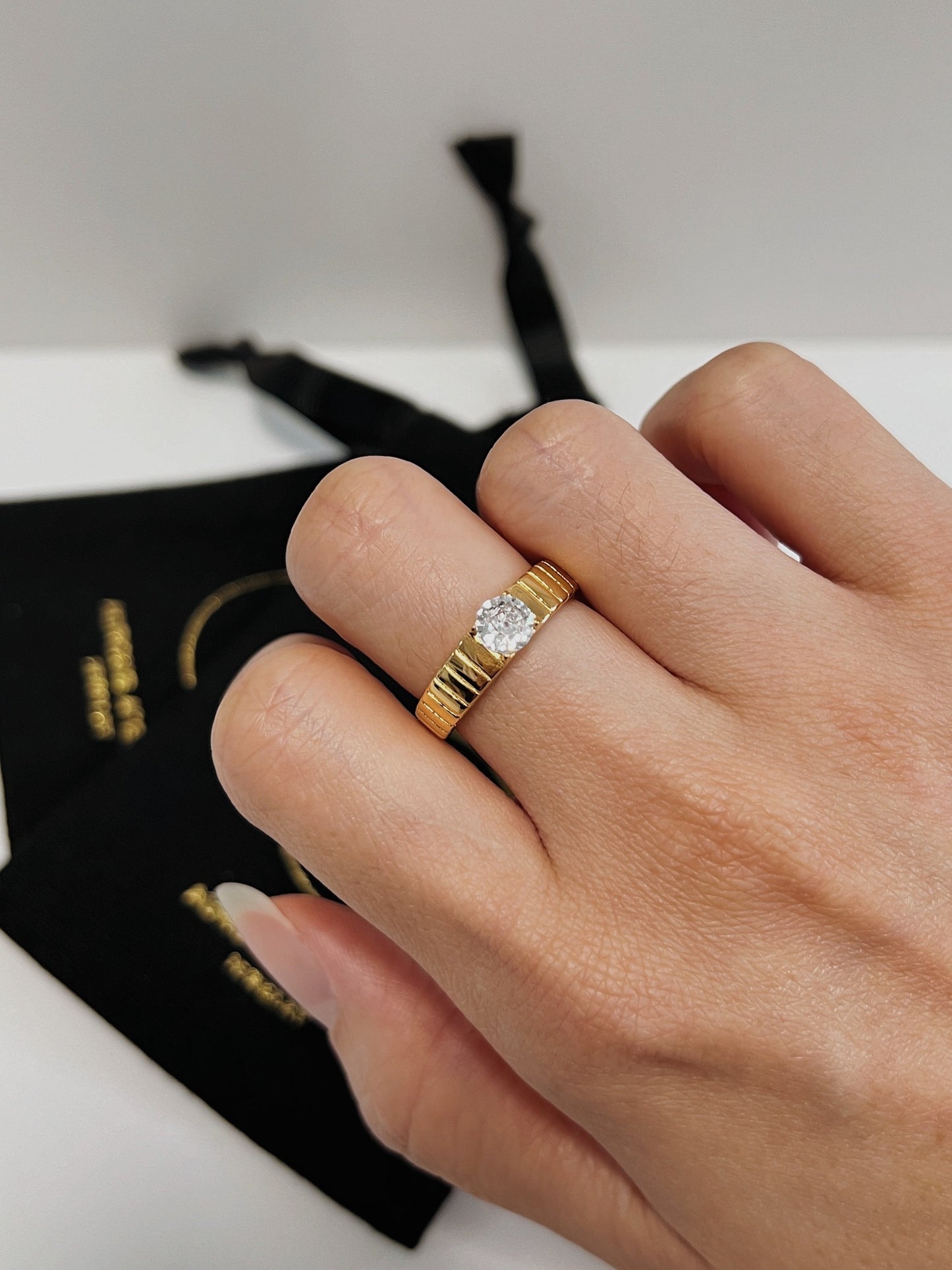 Model wearing the Slim Kass Ring on the middle finger for a quiet luxury look.