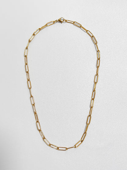 Overhead view of the Sofia paperclip chain necklace highlighting its 4mm flat elongated capsule loop profile on a white display