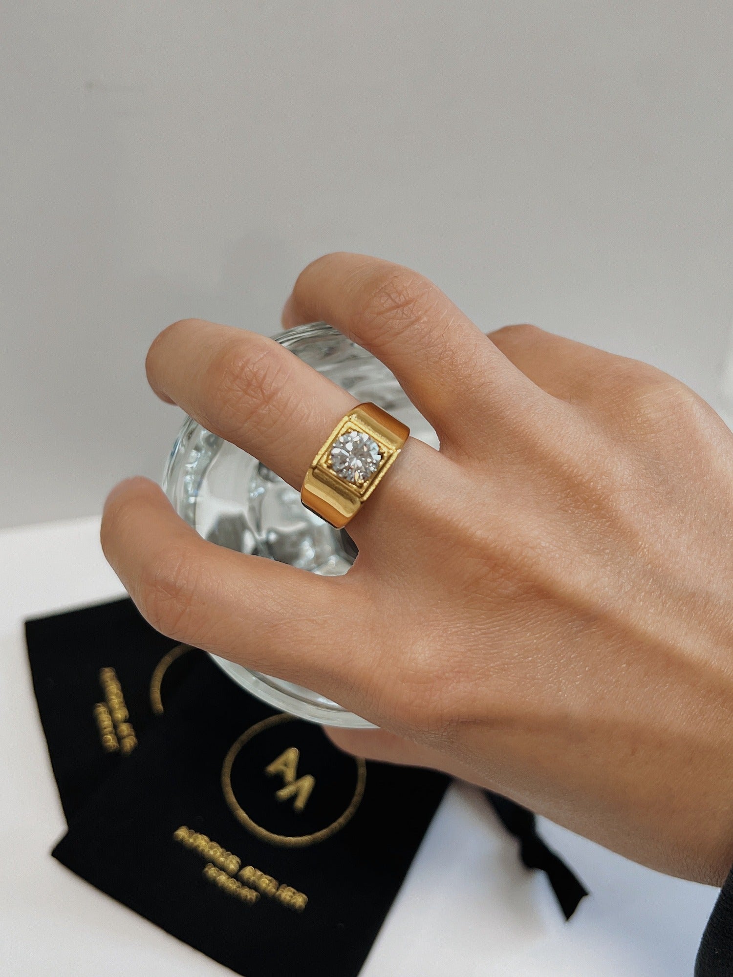 Model gesturing showing the comfortable fit of the chunky gold signet.