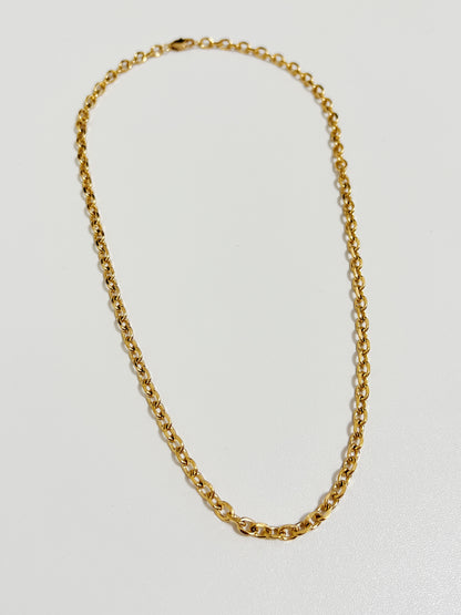 Streamlined low profile lobster clasp attachment on a mid century inspired gold round link chain