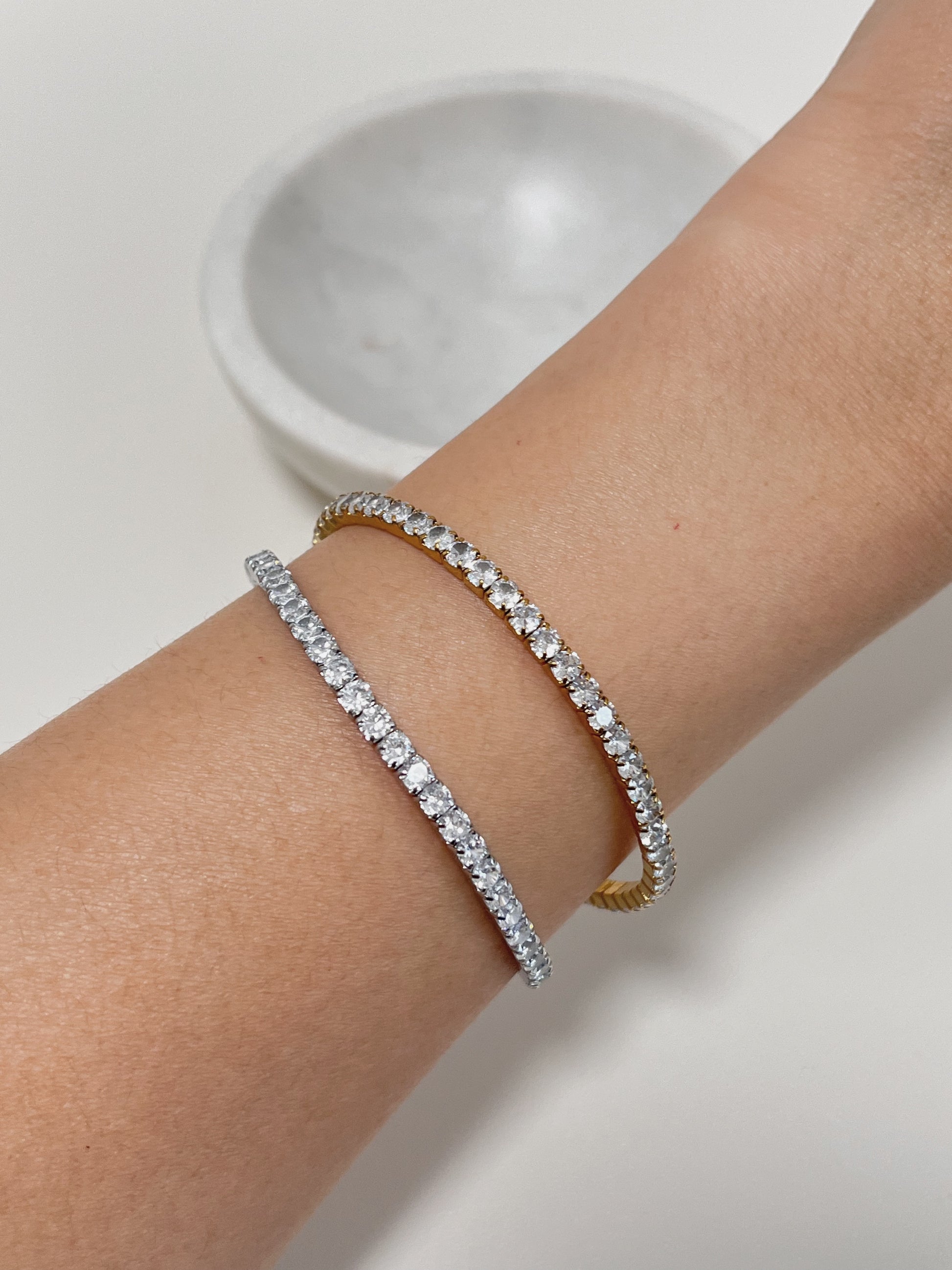 Close up of 3mm 5A cubic zirconia stones on gold and silver tennis bracelet