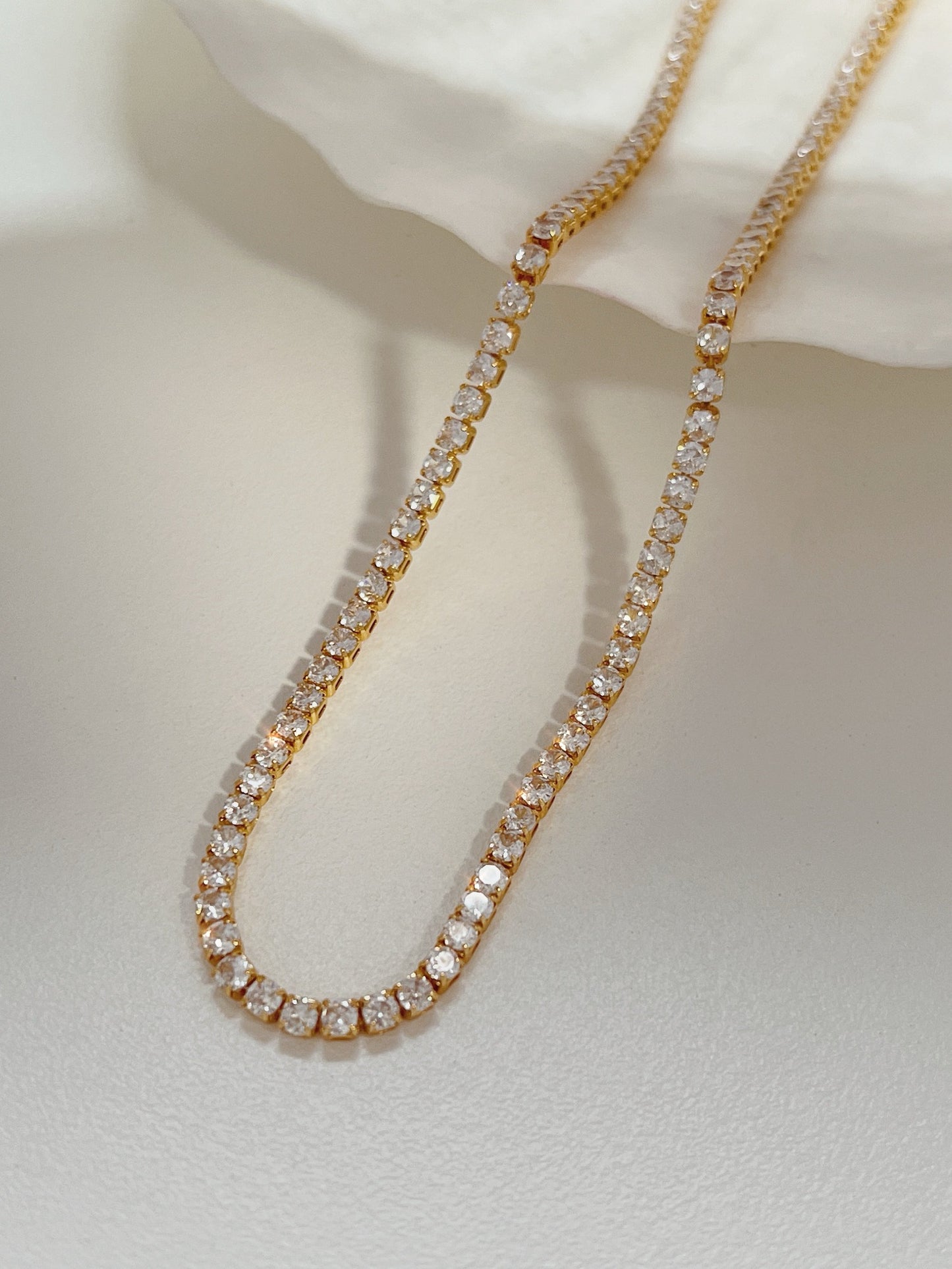 Close up view of fine high polish 2.5mm 5A cubic zirconia crystals in gold settings