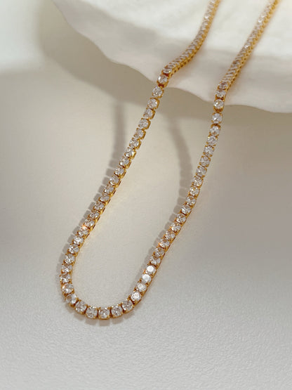 Close up view of fine high polish 2.5mm 5A cubic zirconia crystals in gold settings