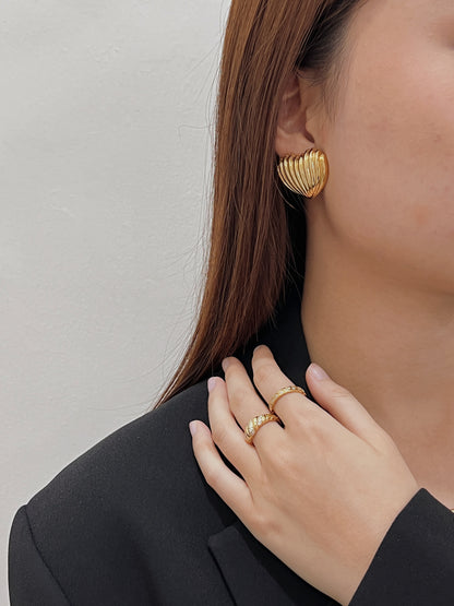 Model wearing the gold Claudia ring with a tailored evening blazer.