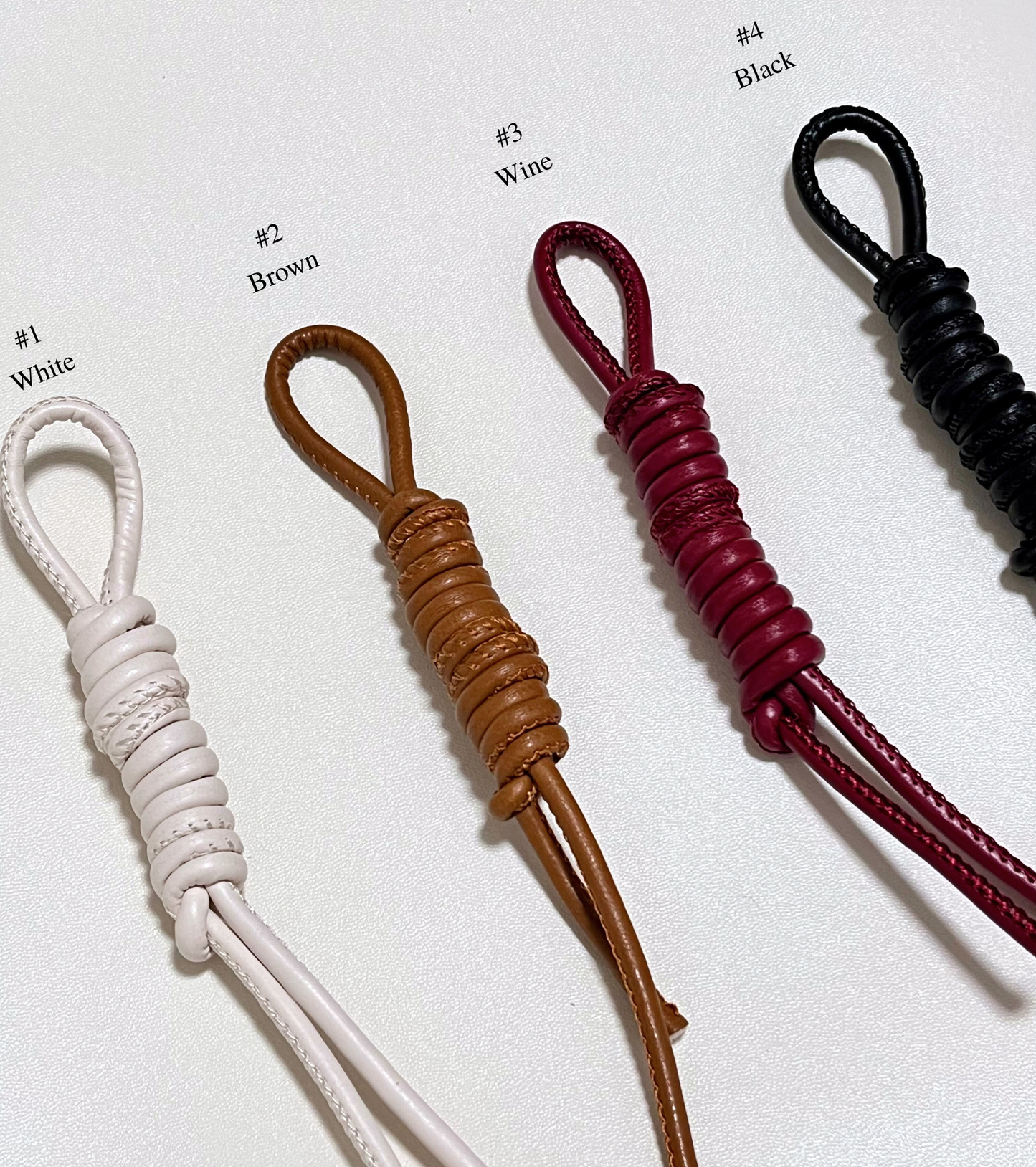 Four leather straps in different colors for personalized option.