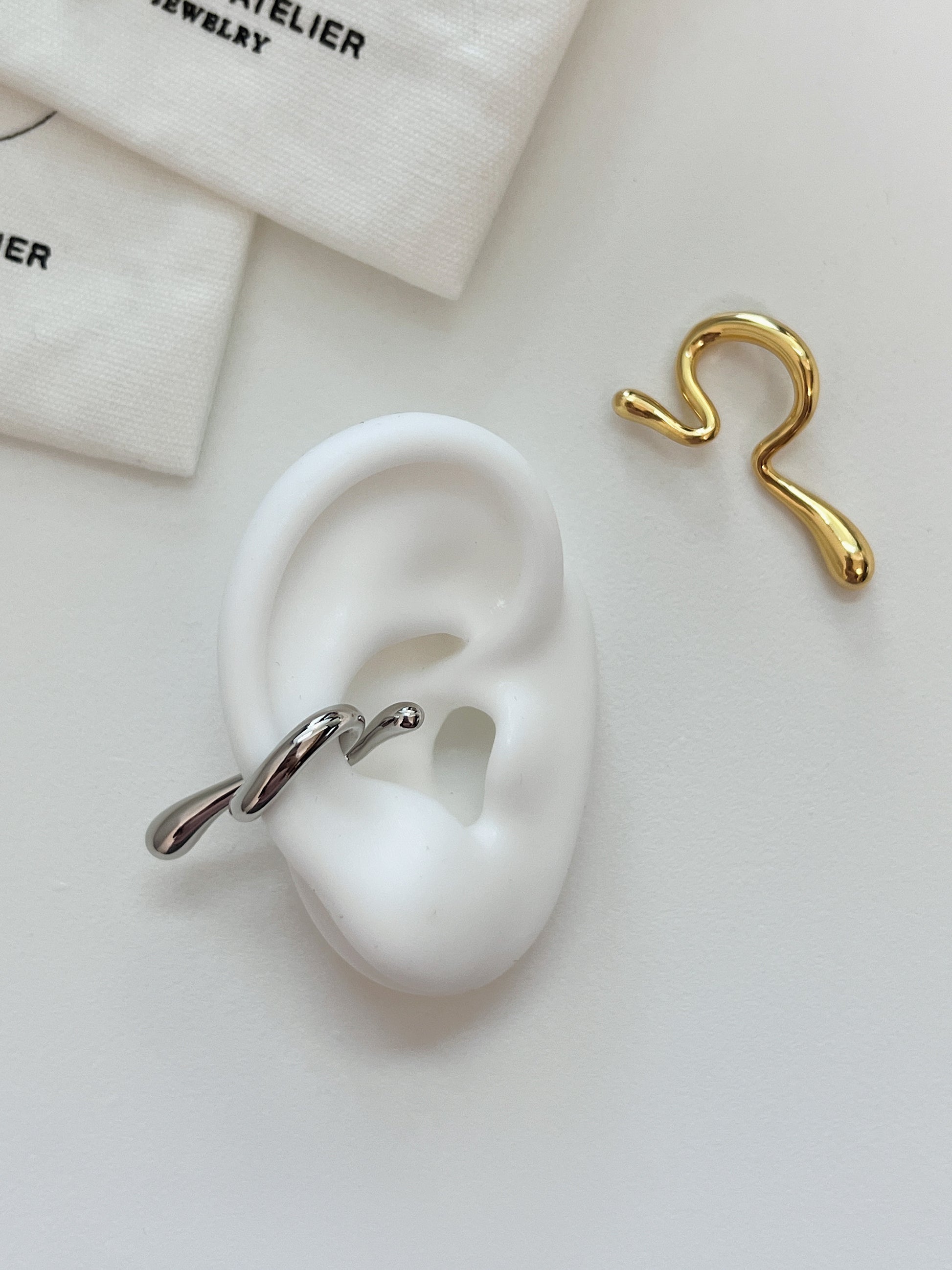 Waterproof 18K gold PVD jewelry for unpierced ears showcasing molten form.