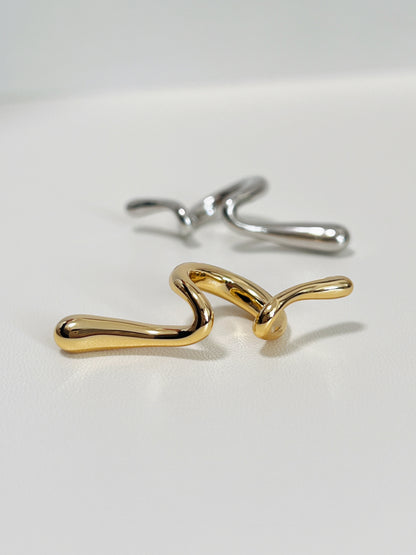 Macro detail of the 18K Gold PVD coating on the smooth, rounded edges of the Parker cuff.