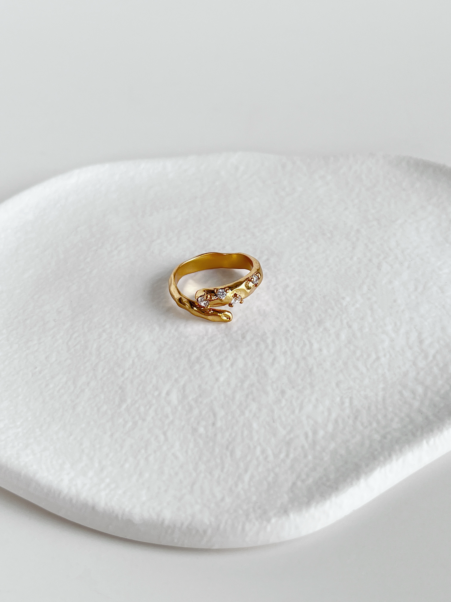 Hand-set 5a cubic zirconia on gold hammered brass ring showing brilliance