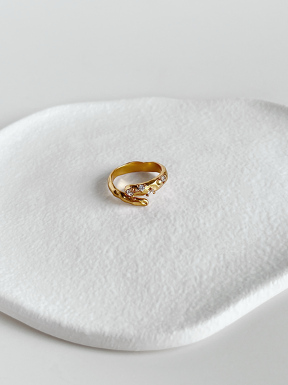 Hand-set 5a cubic zirconia on gold hammered brass ring showing brilliance