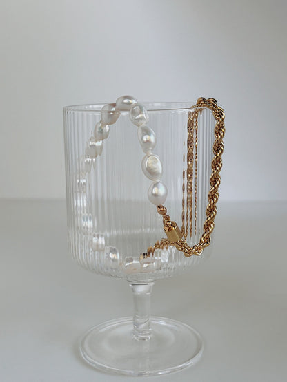 Asymmetrical gold rope chain and natural oval freshwater pearl necklace layout