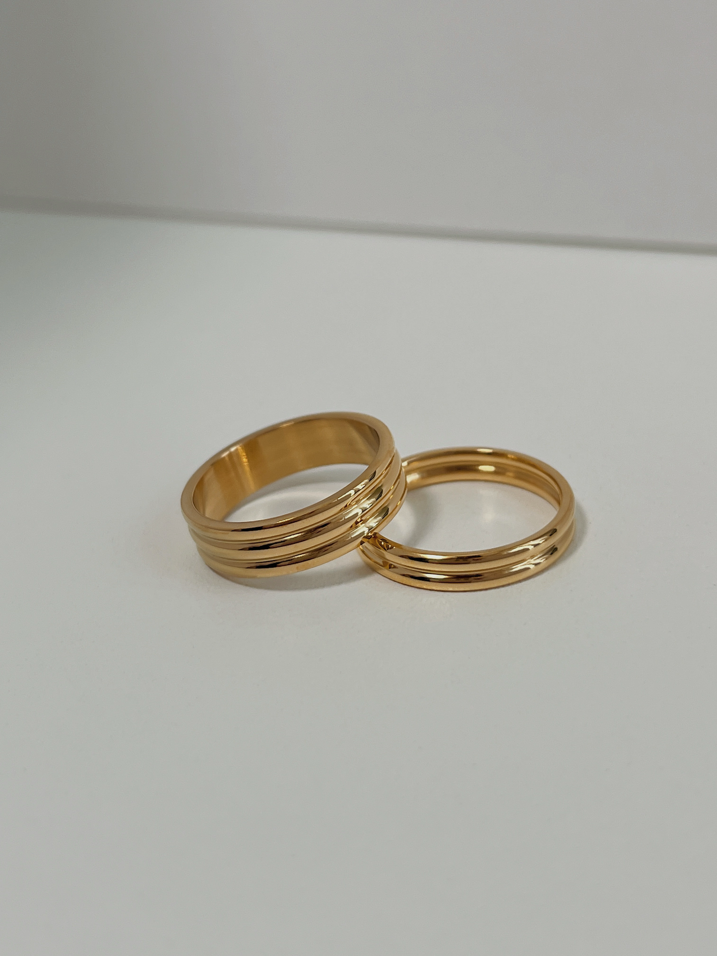 Comparison of slim and thick gold ribbed rings for stacking