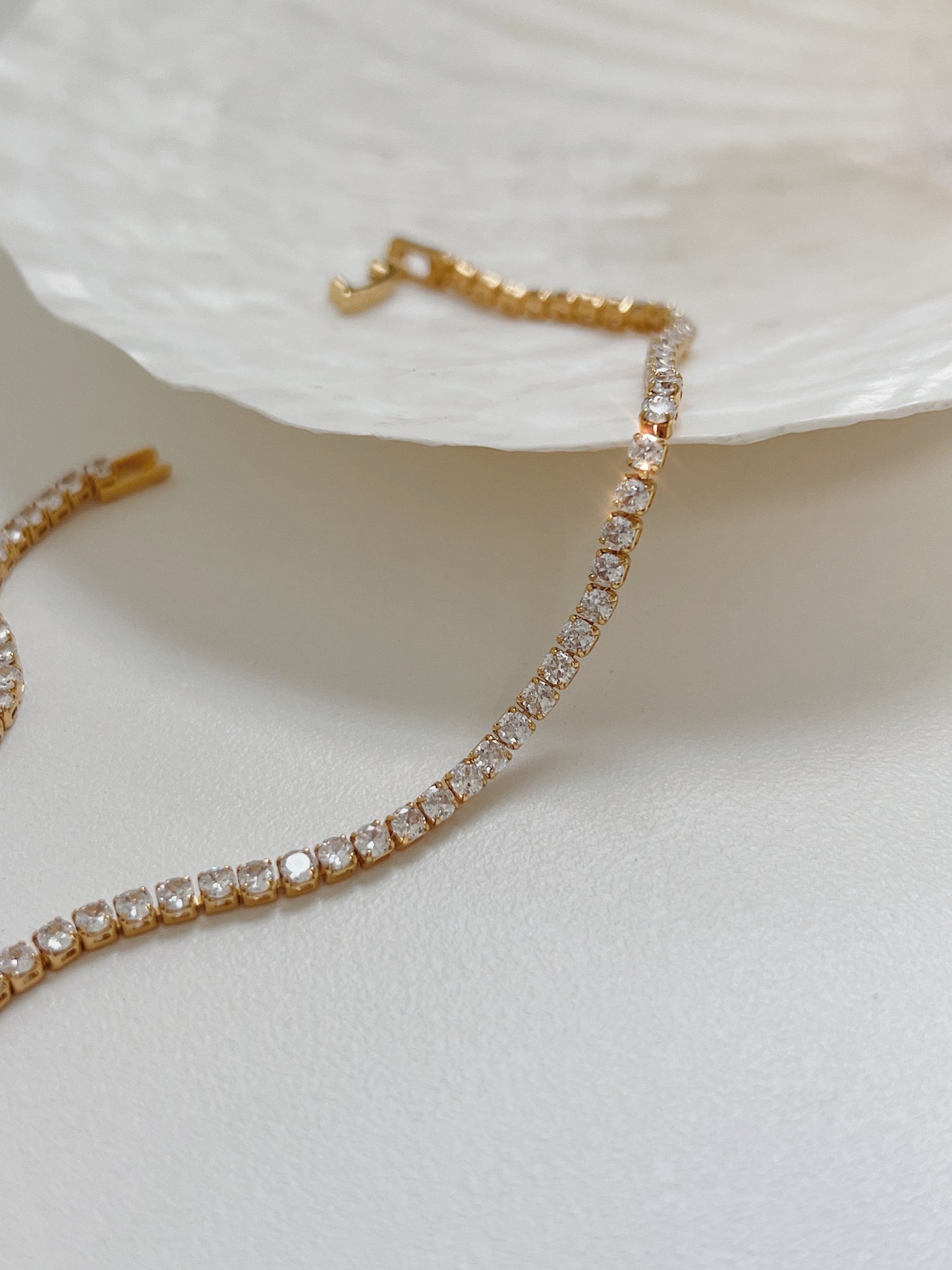 Contemporary luxury statement necklace showcasing single row of mirror polished stones catching light