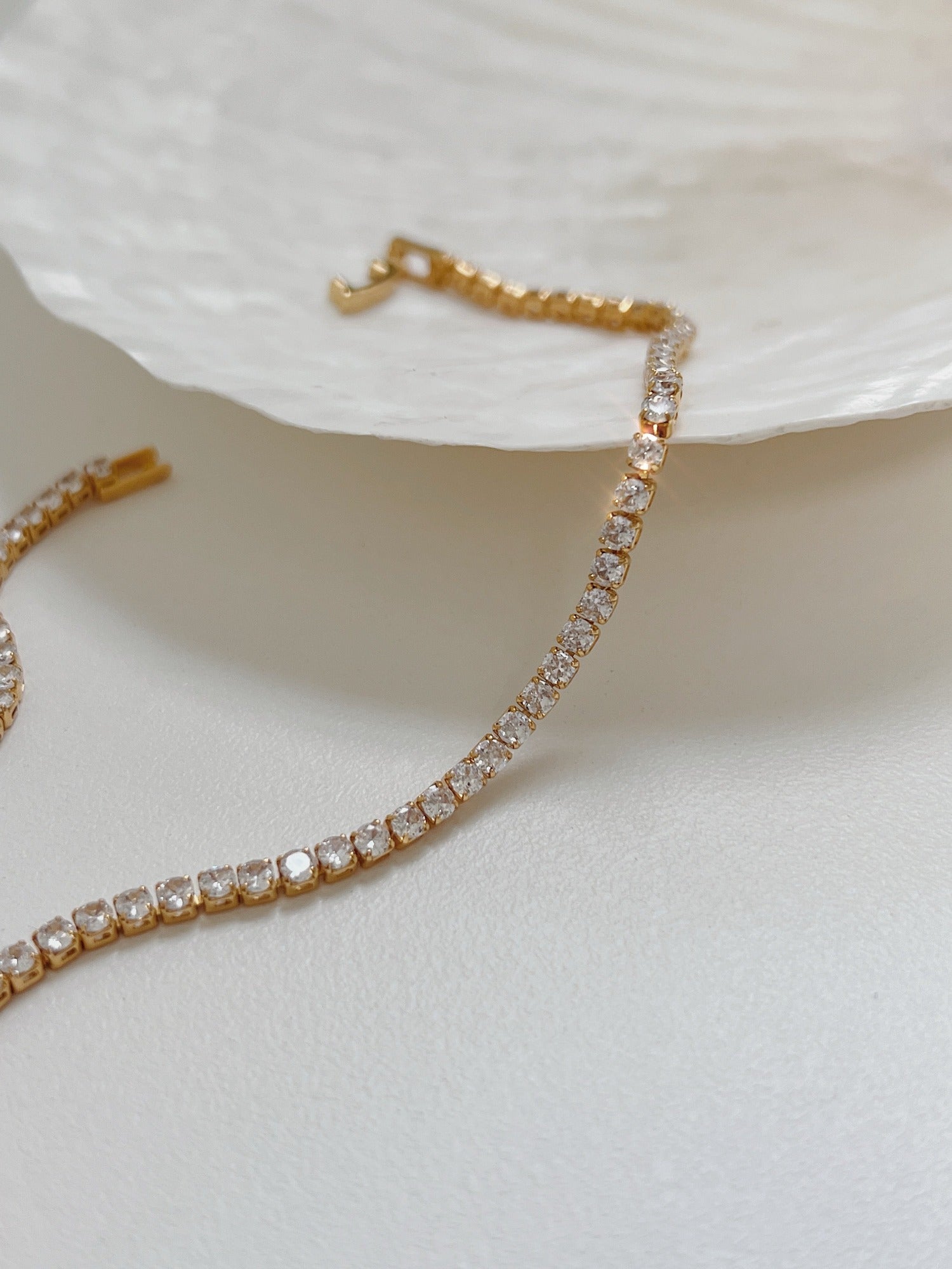 Contemporary luxury statement necklace showcasing single row of mirror polished stones catching light