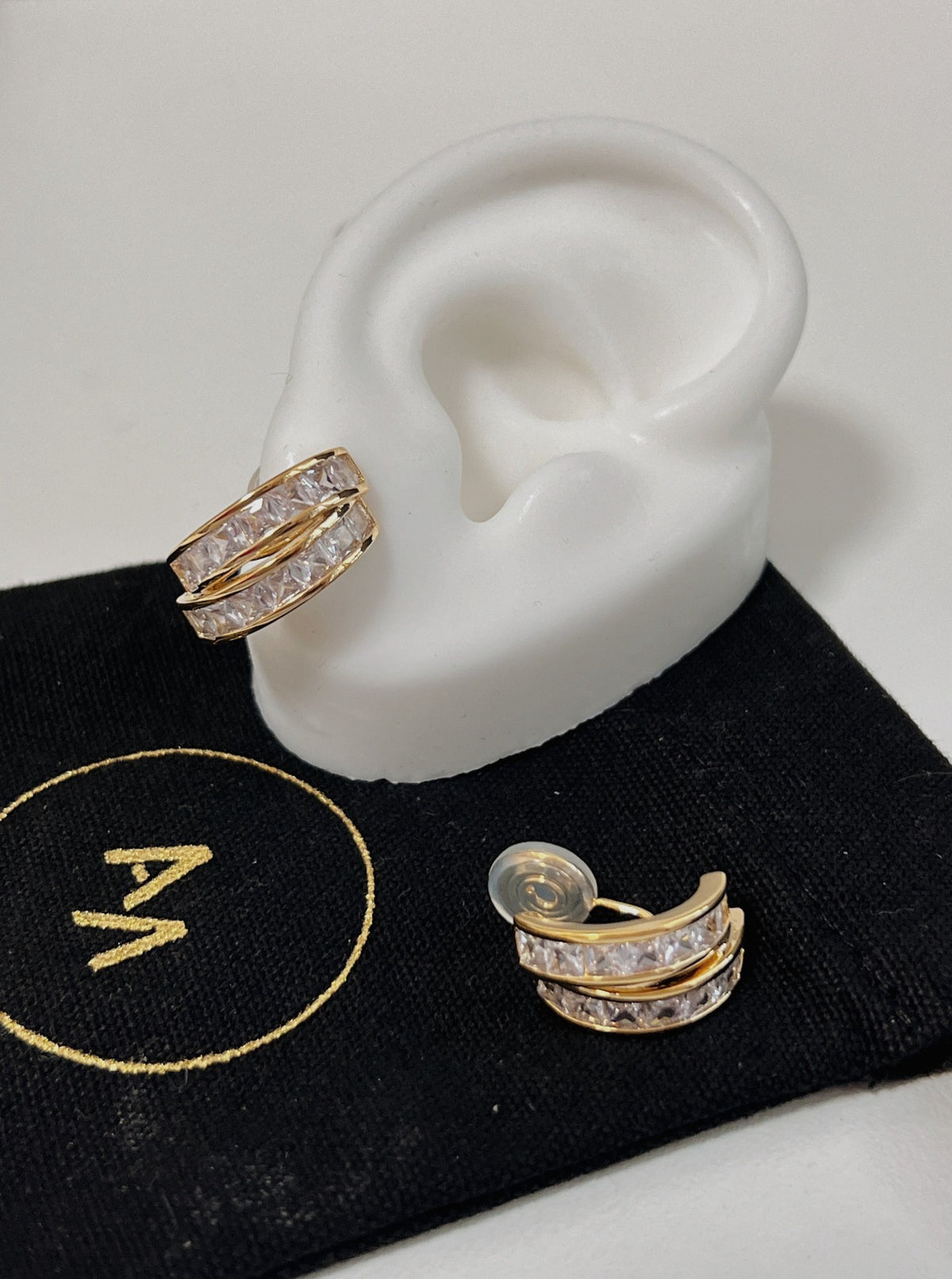 Dual rail gold architecture flanking channel set CZ stones on Tiana 14k gold plated clip-on huggie