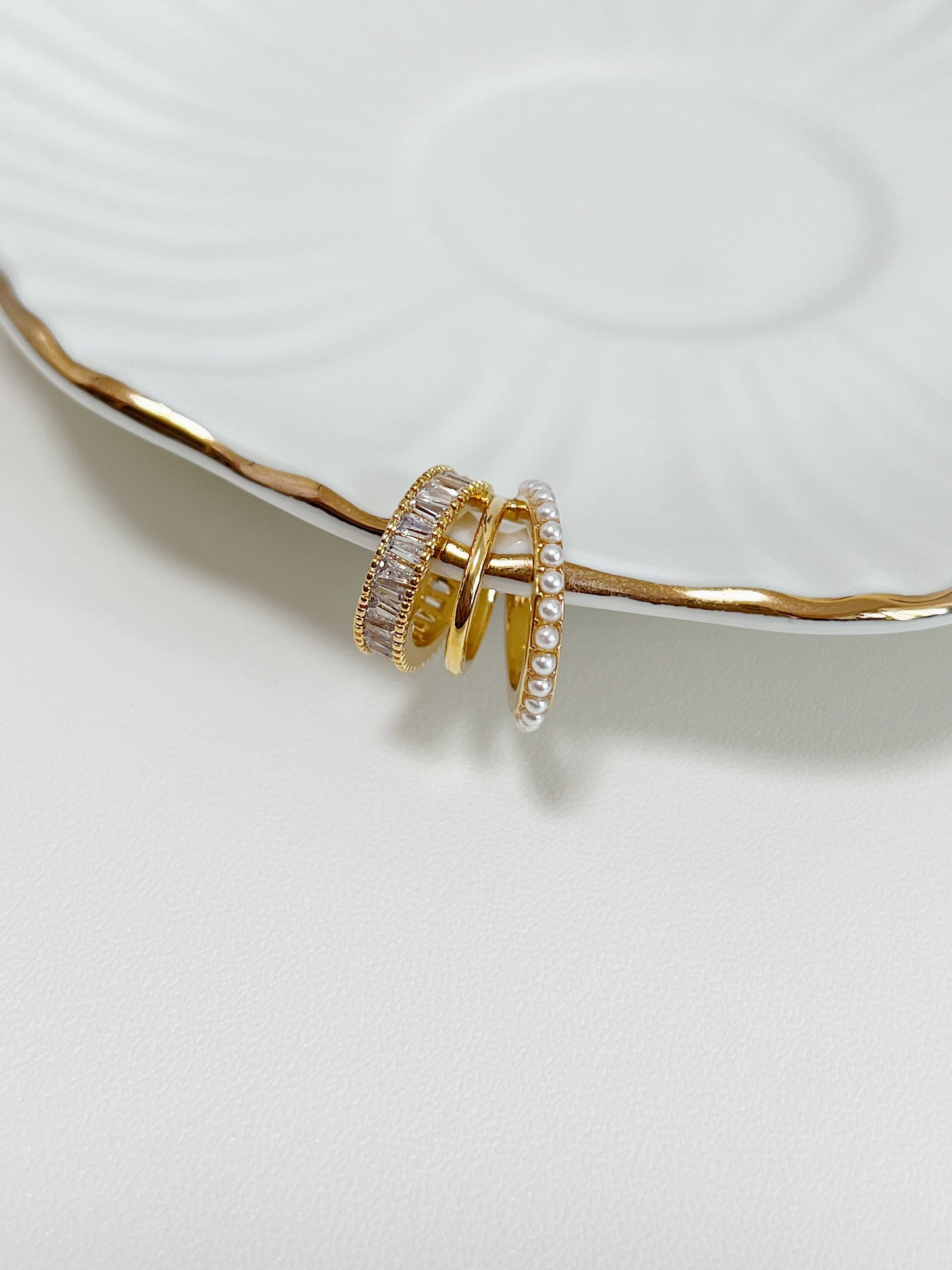 Side view of 18k gold PVD triple band ear cuff.