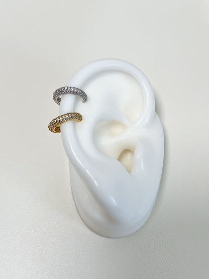 The Rose 18K Gold Vermeil Ear Cuff presented on a minimalist architectural display, ideal for luxury jewelry gifting.