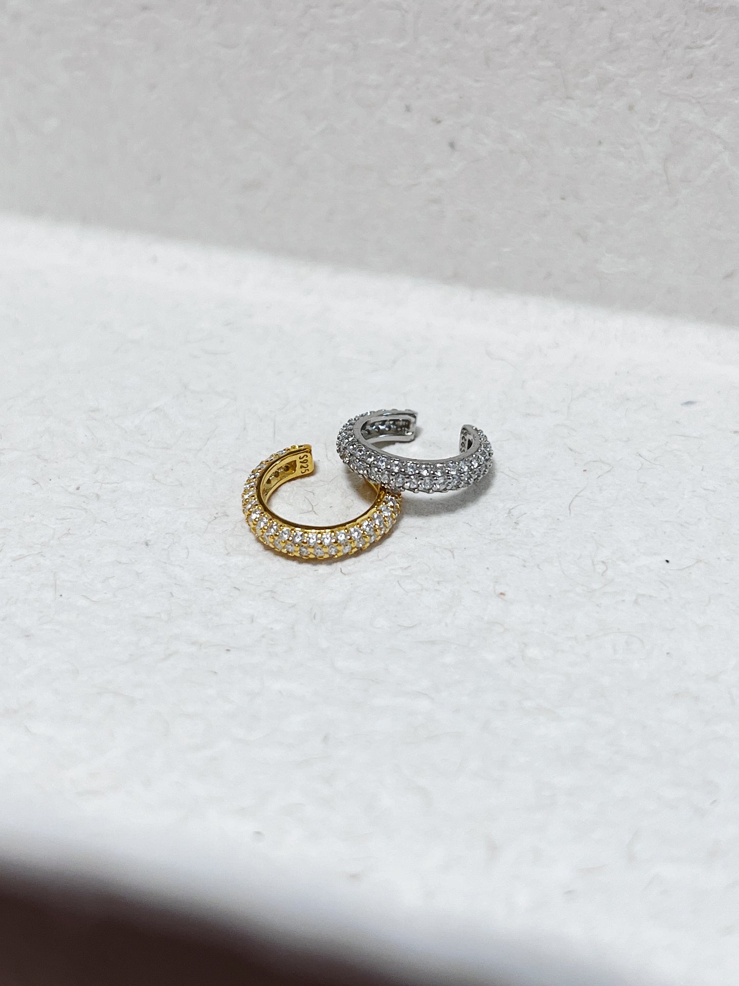 Comparison shot of the gold and silver Rose cuffs showing the pavé density.