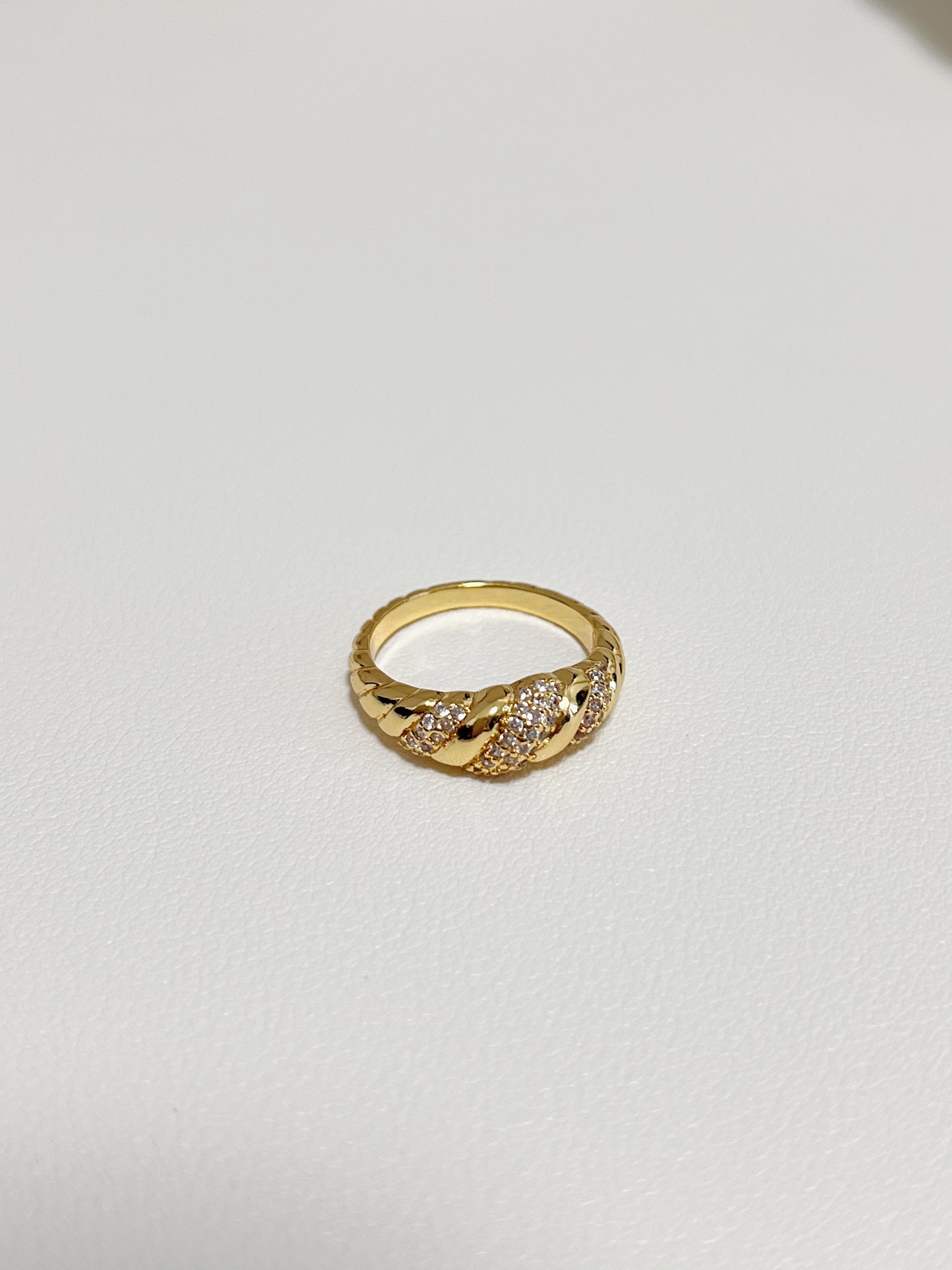Close-up of the twisted croissant silhouette and pavé setting on the Claudia ring.