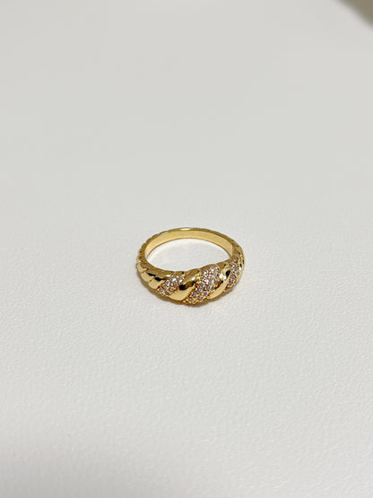 Close-up of the twisted croissant silhouette and pavé setting on the Claudia ring.