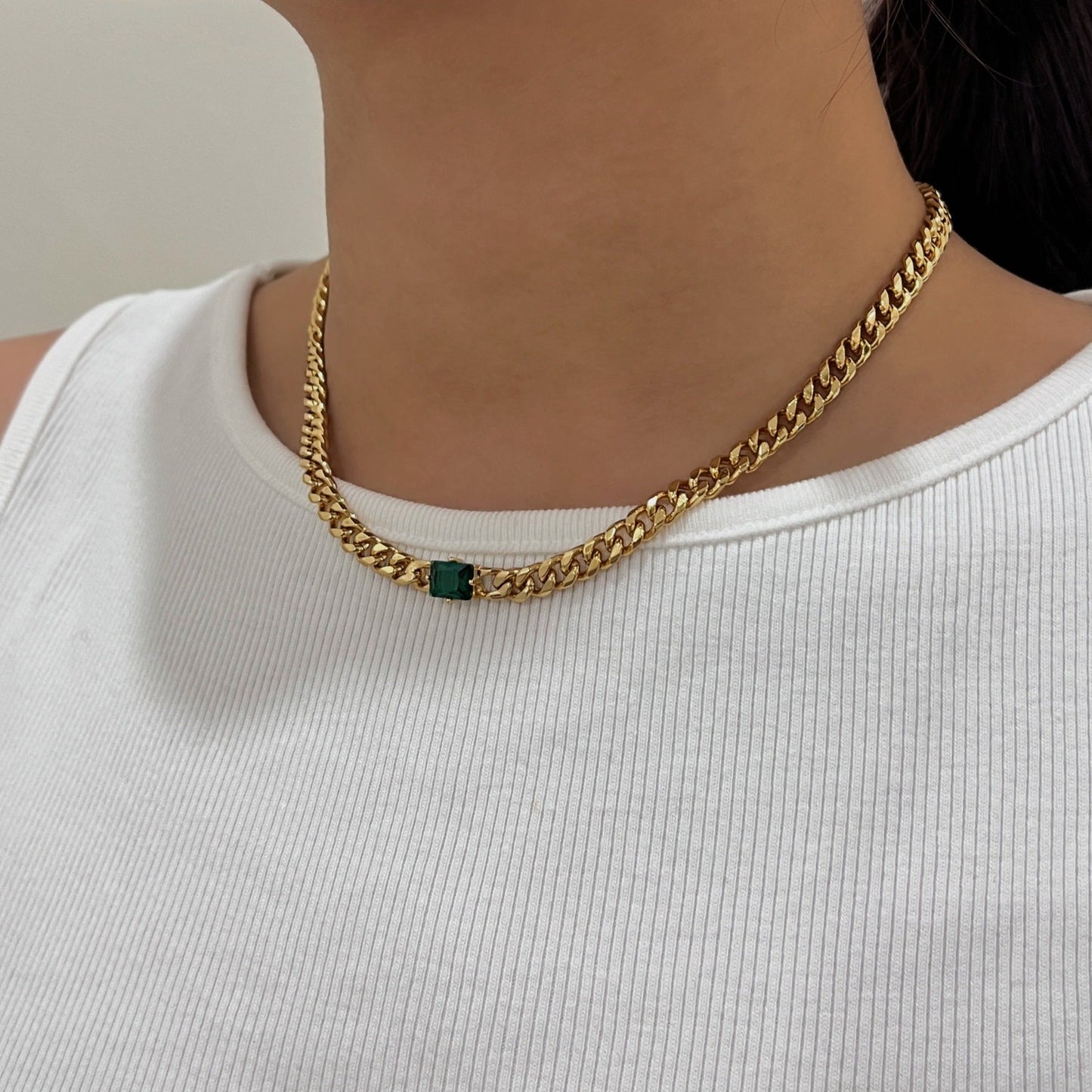 Woman neckline displaying modern 18k gold PVD Cuban link pendant placement