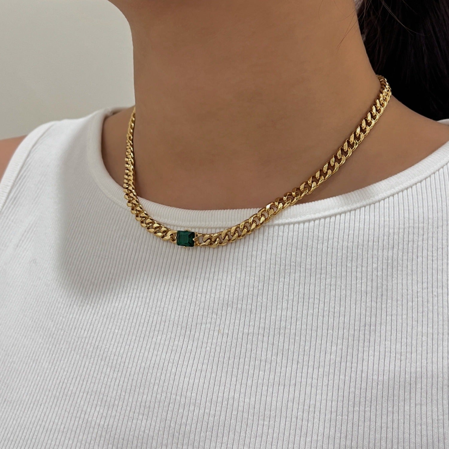 Woman neckline displaying modern 18k gold PVD Cuban link pendant placement