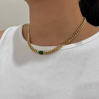 Woman neckline displaying modern 18k gold PVD Cuban link pendant placement