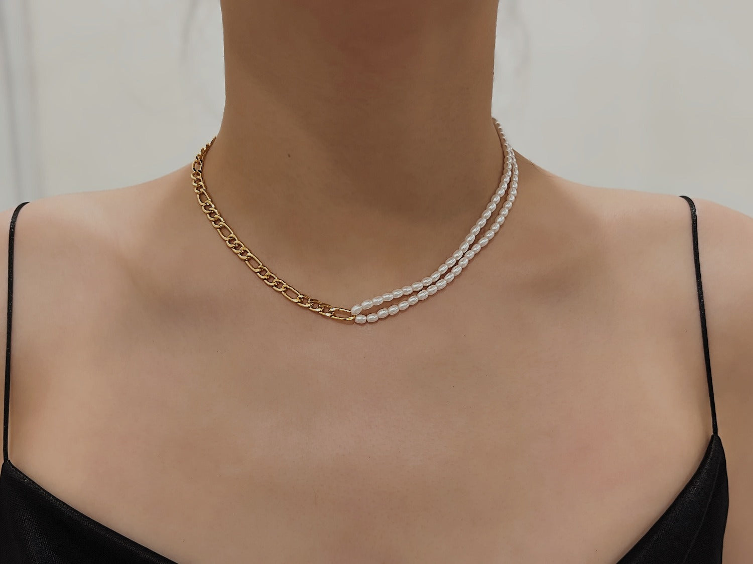 Double layer mini freshwater pearl strand transitioning into a single polished gold chain