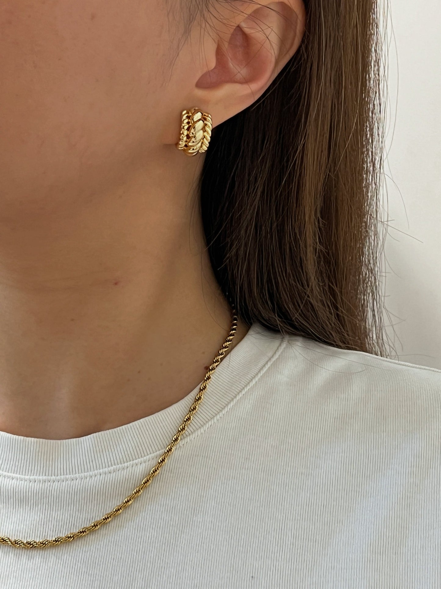 Close-up of a model's ear highlighting the flawless 'pierced-look' illusion.