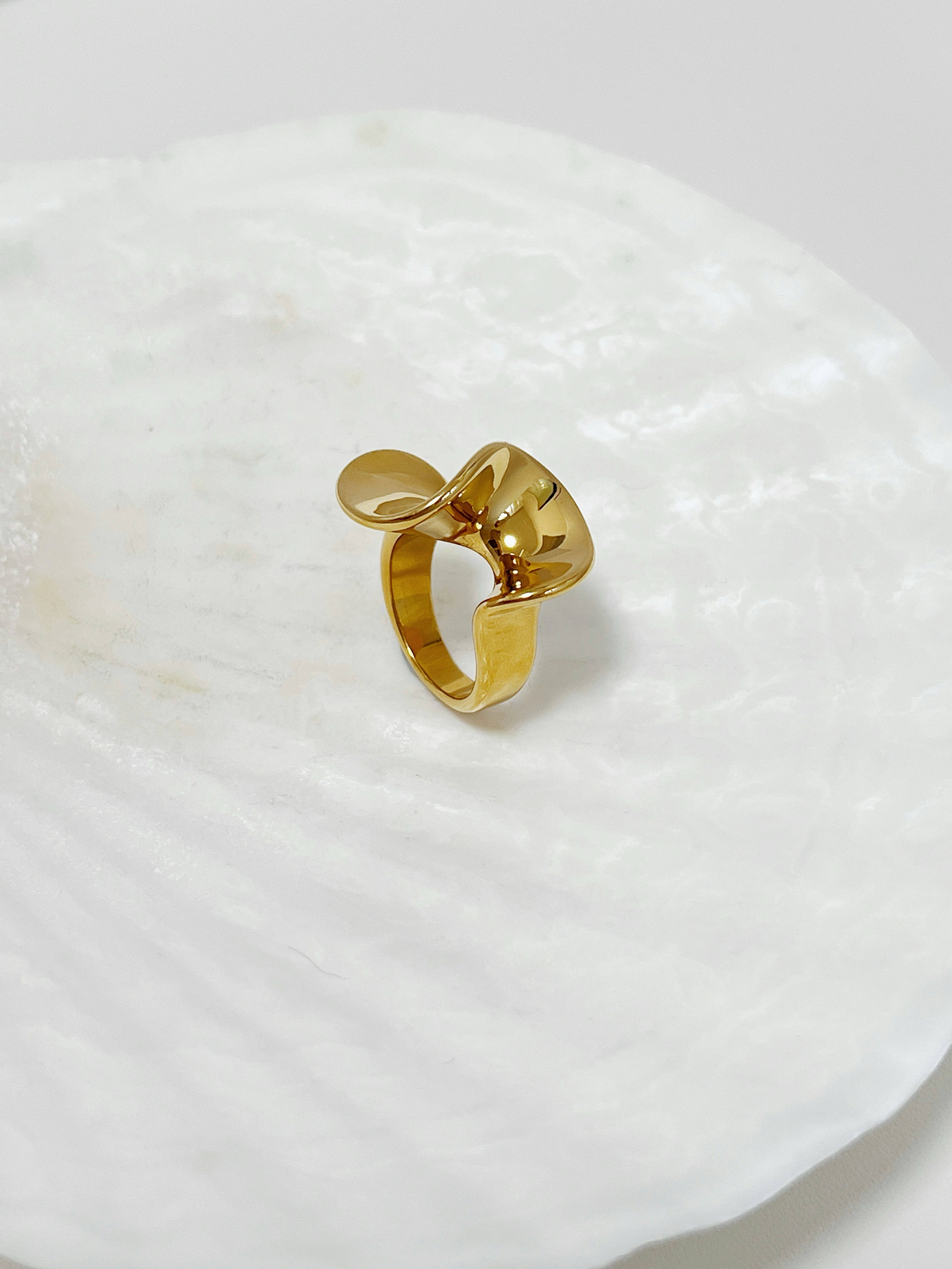 Chunky gold rings for women highlighting the continuous undulating finish