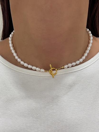 Close up view of a woman styled with a clean sleek straight hair look wearing genuine freshwater pearl jewellery