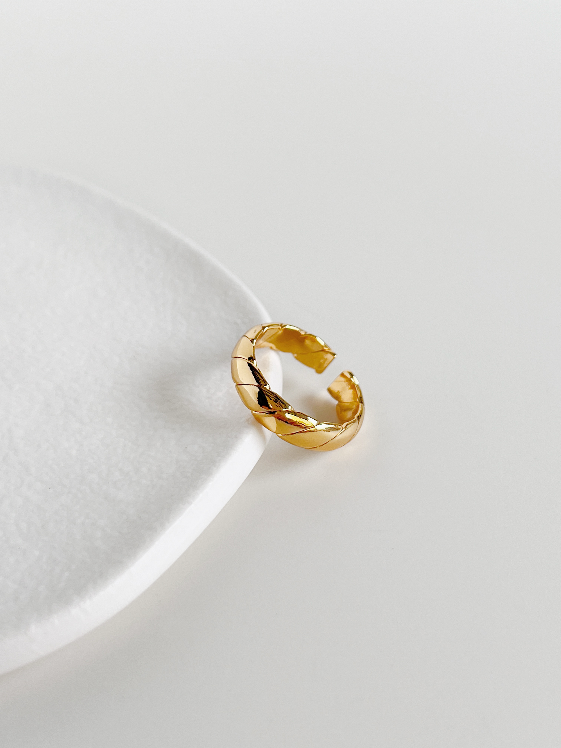 Everyday waterproof gold jewellery flat lay on minimalist white surface