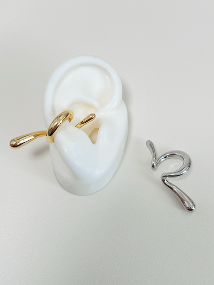 Close-up of white's silicone ear with the gold Parker cuff for a minimalist stack.