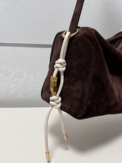 White leather personalized initial bag charm.