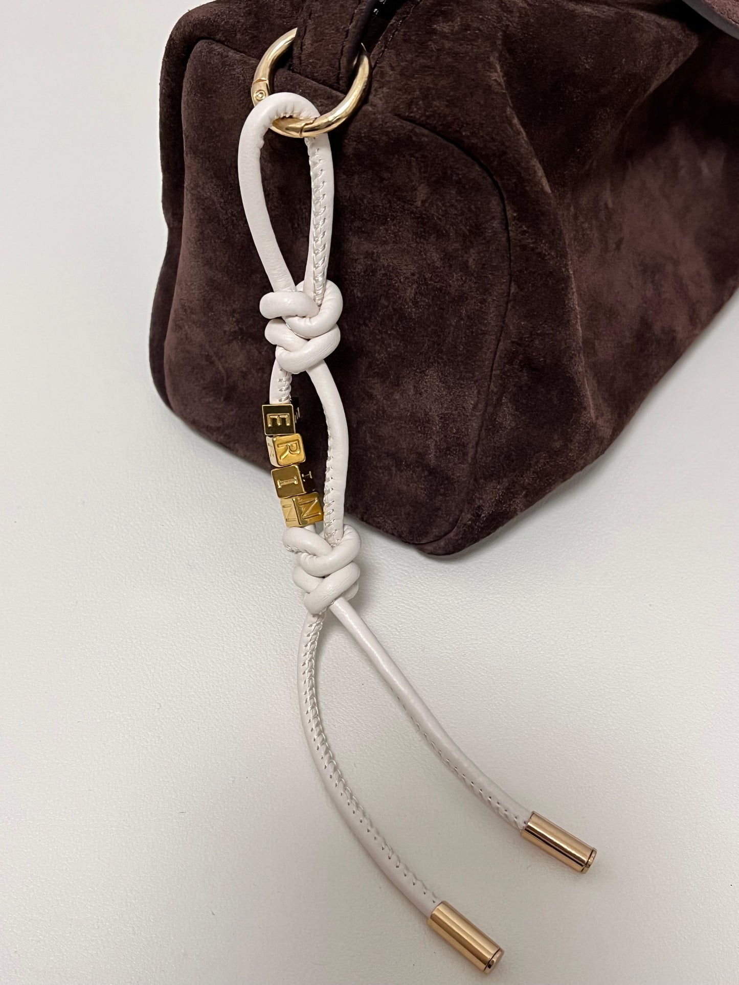 White leather bag charm with artisan beaded accent