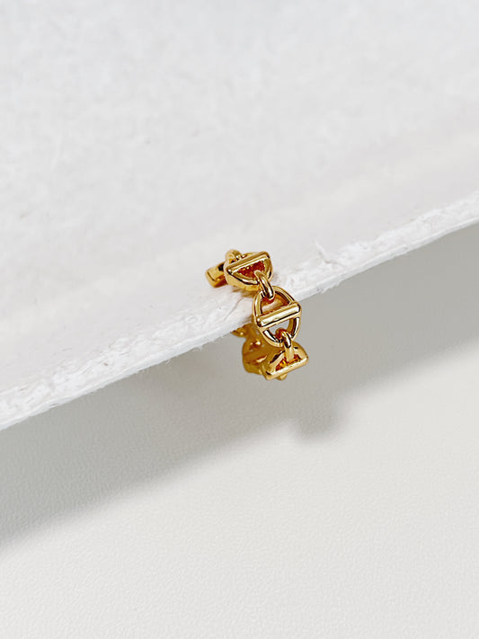 Macro of gold Windsor Link Ear Cuff showing the interlocking nautical motif and 18K PVD finish.