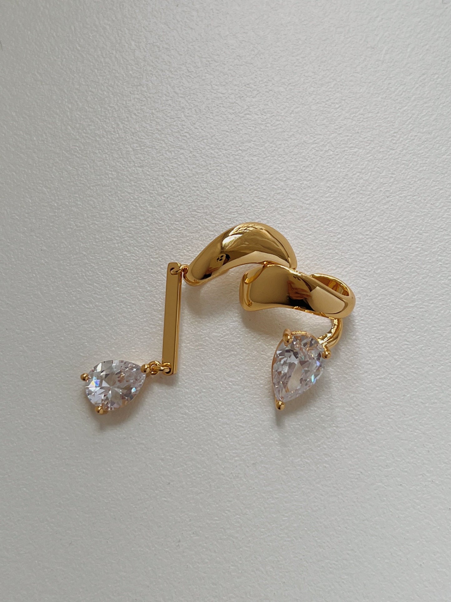 Close-up of pear-cut 5A Zirconia on gold cuff