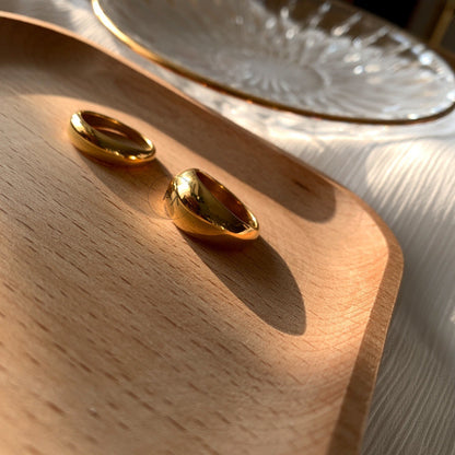 Comparison of slim and thick gold dome ring silhouettes in mirror finish