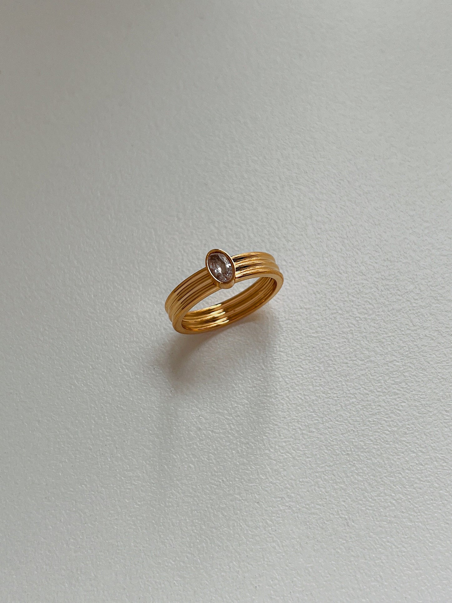 Gold ribbed statement band with 5A grade cubic zirconia oval stone